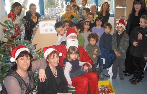 A gauche, Marisa Chemin, adjointe et Josie Demaria, responsable de la BDthèque, accueillent les enfants et le Père Noël.